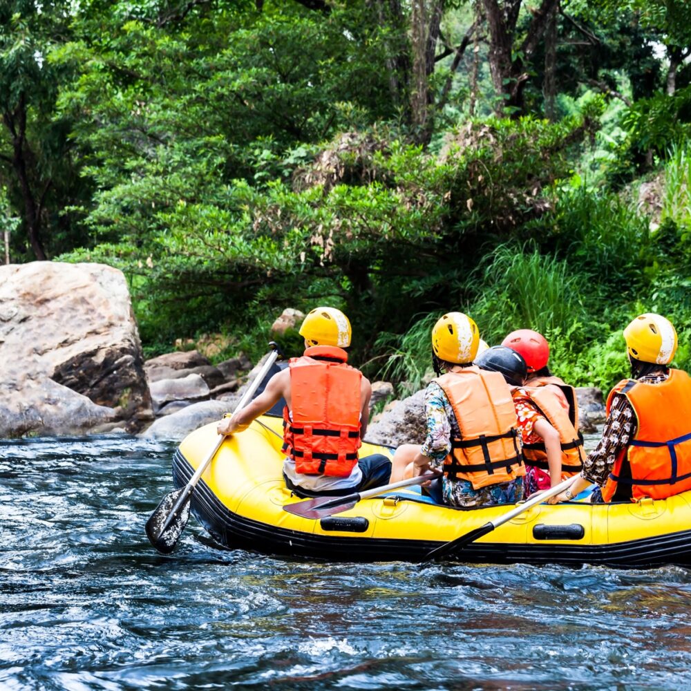 A group of men and women are rafting on the river, extreme and fun sport